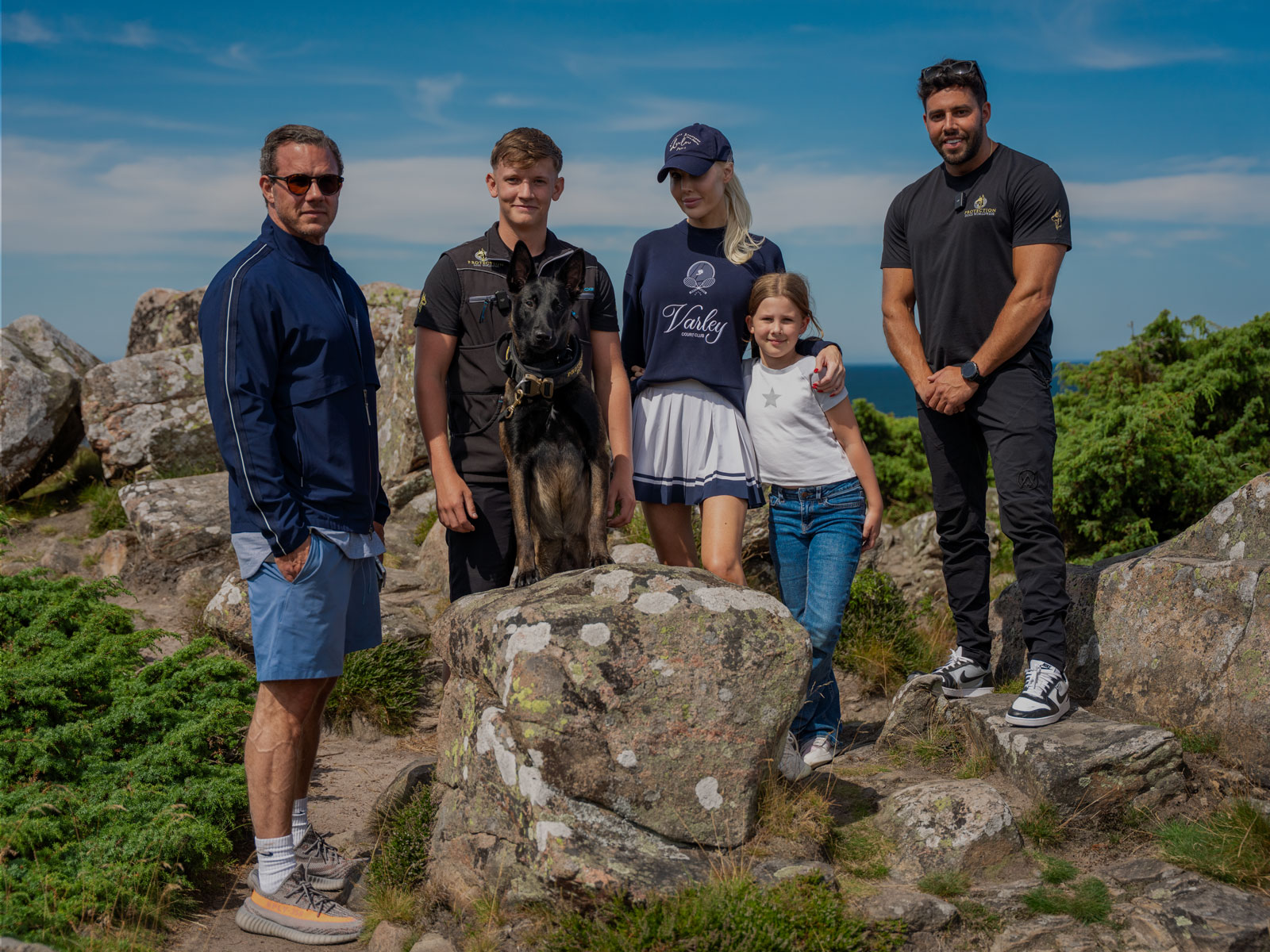 A belgium malinois sat with there new owners. Provided by Protection Dogs Worldwide, the leaders in protection dogs for high net worth individuals alongisde owner Leedor Borlant and Senior Dog Trainer Harvey 